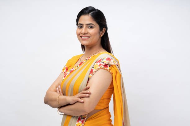 Portrait of Indian young woman crossed hands wear sari isolated over white background